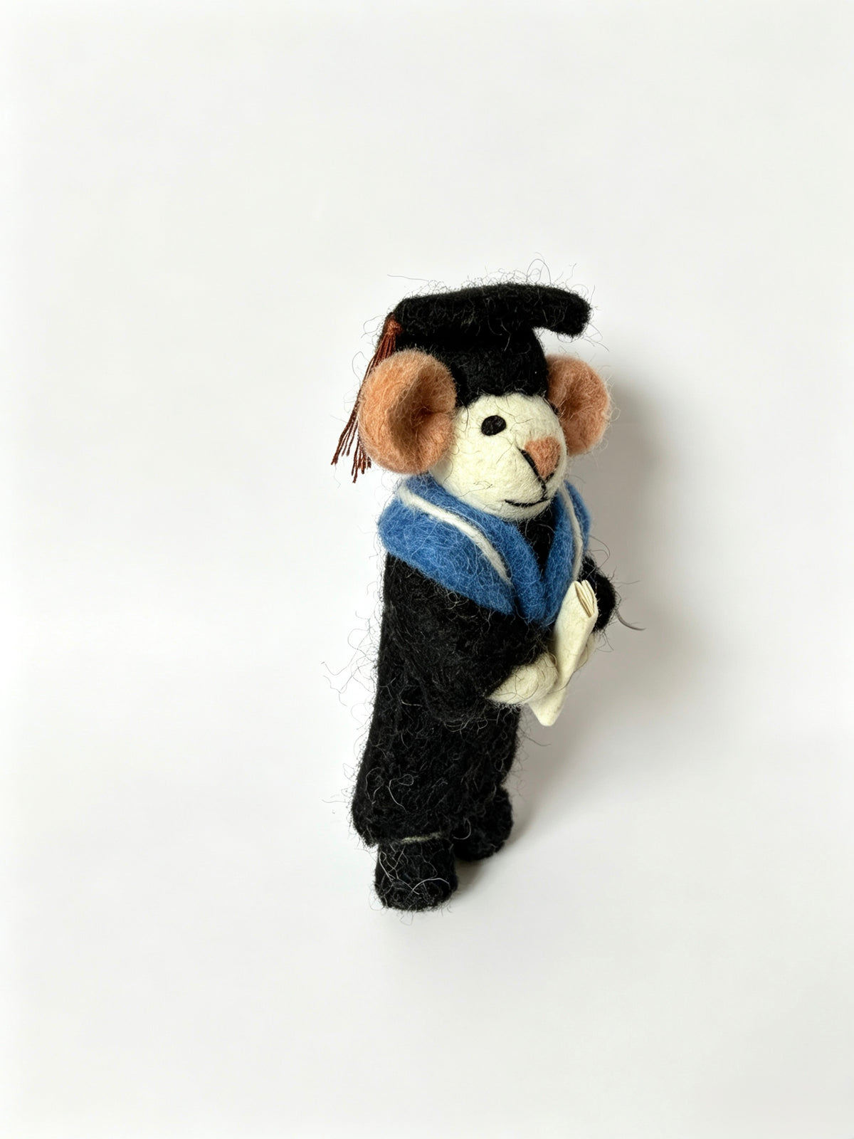 Three quarter view of handmade graduation mouse figurine with black gown