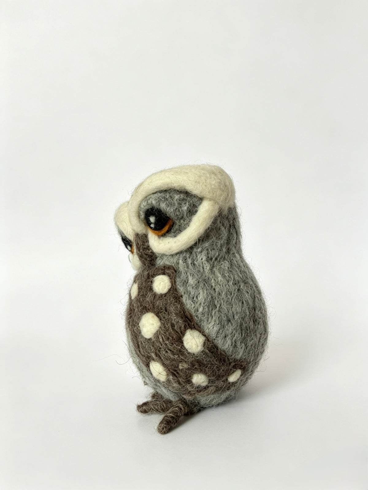 Back view of handmade wool felt owl ornament showing soft grey felt plumage