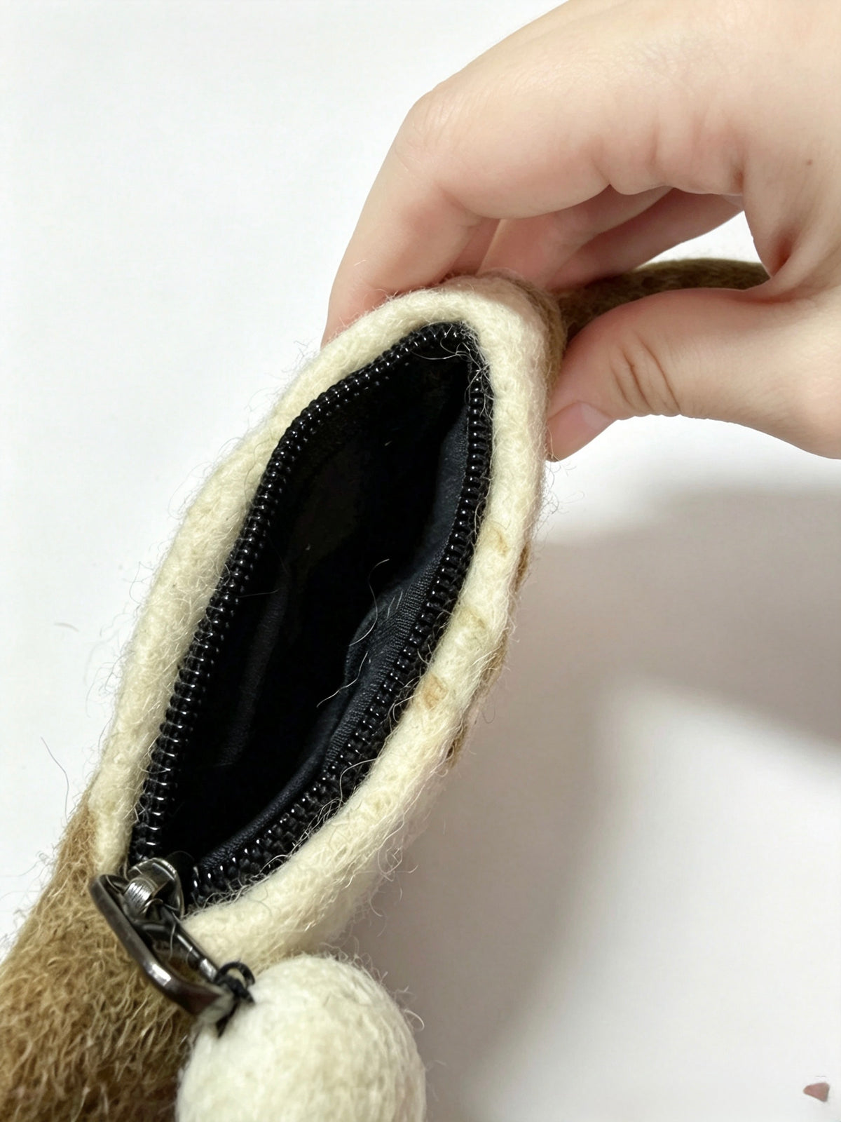 Open zip of handmade wool felt cat coin purse showing black lining