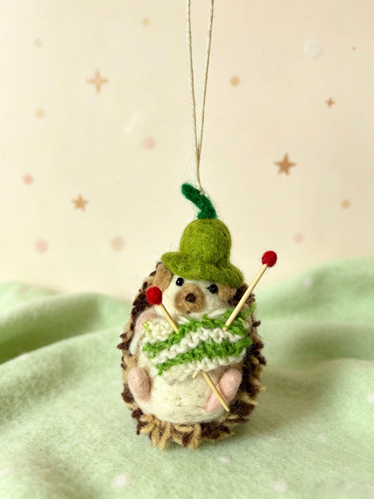 Handmade wool felt hedgehog hanging ornament in a festive decorative scene