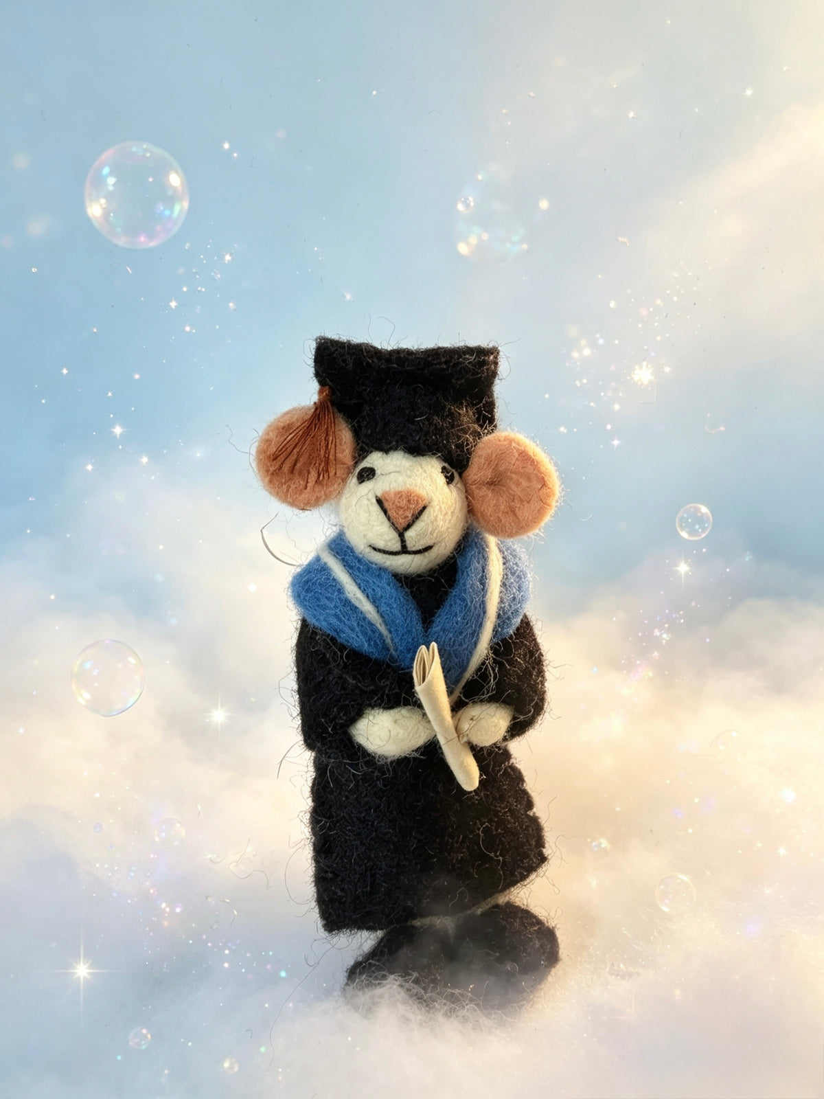 Handmade felt graduation mouse holding a rolled diploma