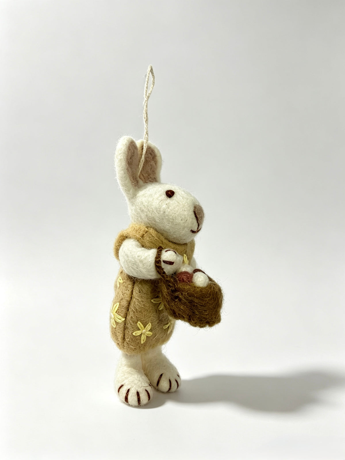Side profile of handmade wool felt bunny rabbit hanging decoration