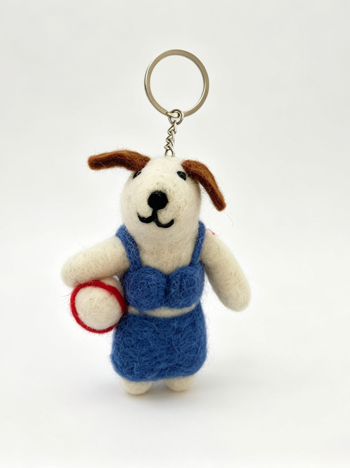 Side view of handmade felt dog keychain in blue beach clothing with volleyball