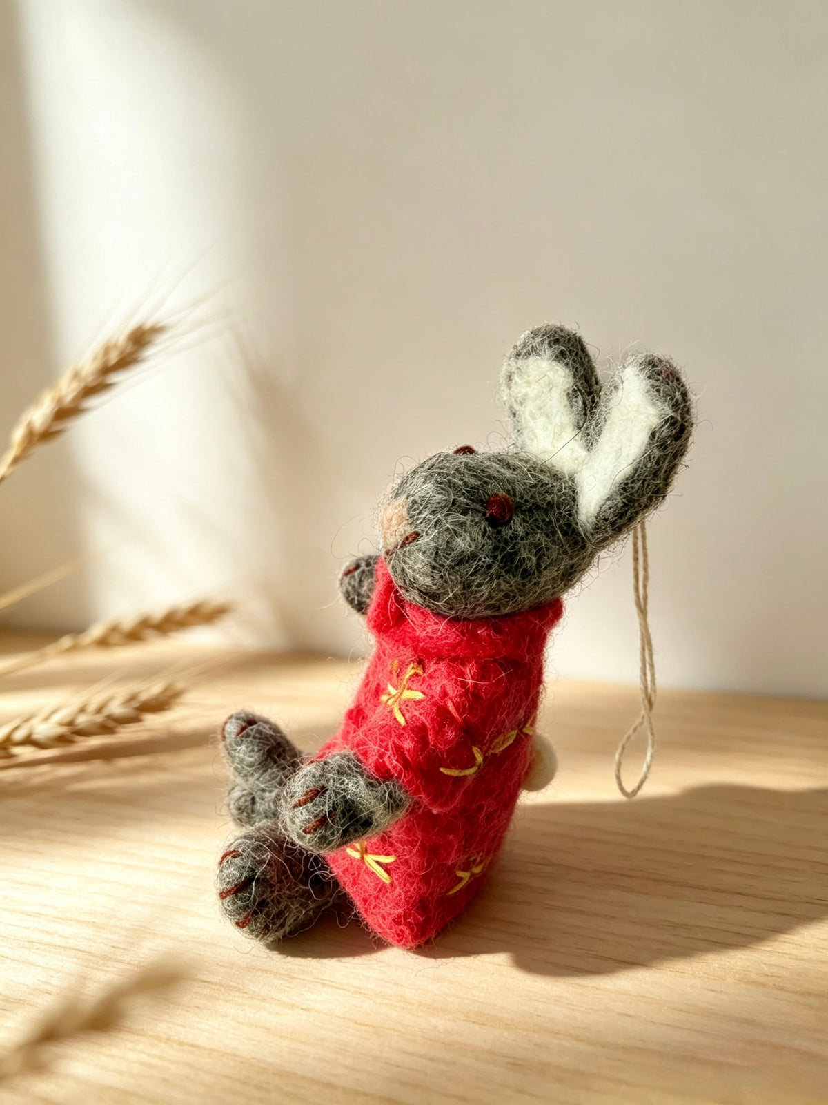 Handmade wool felt bunny rabbit in a red floral outfit hanging decoration