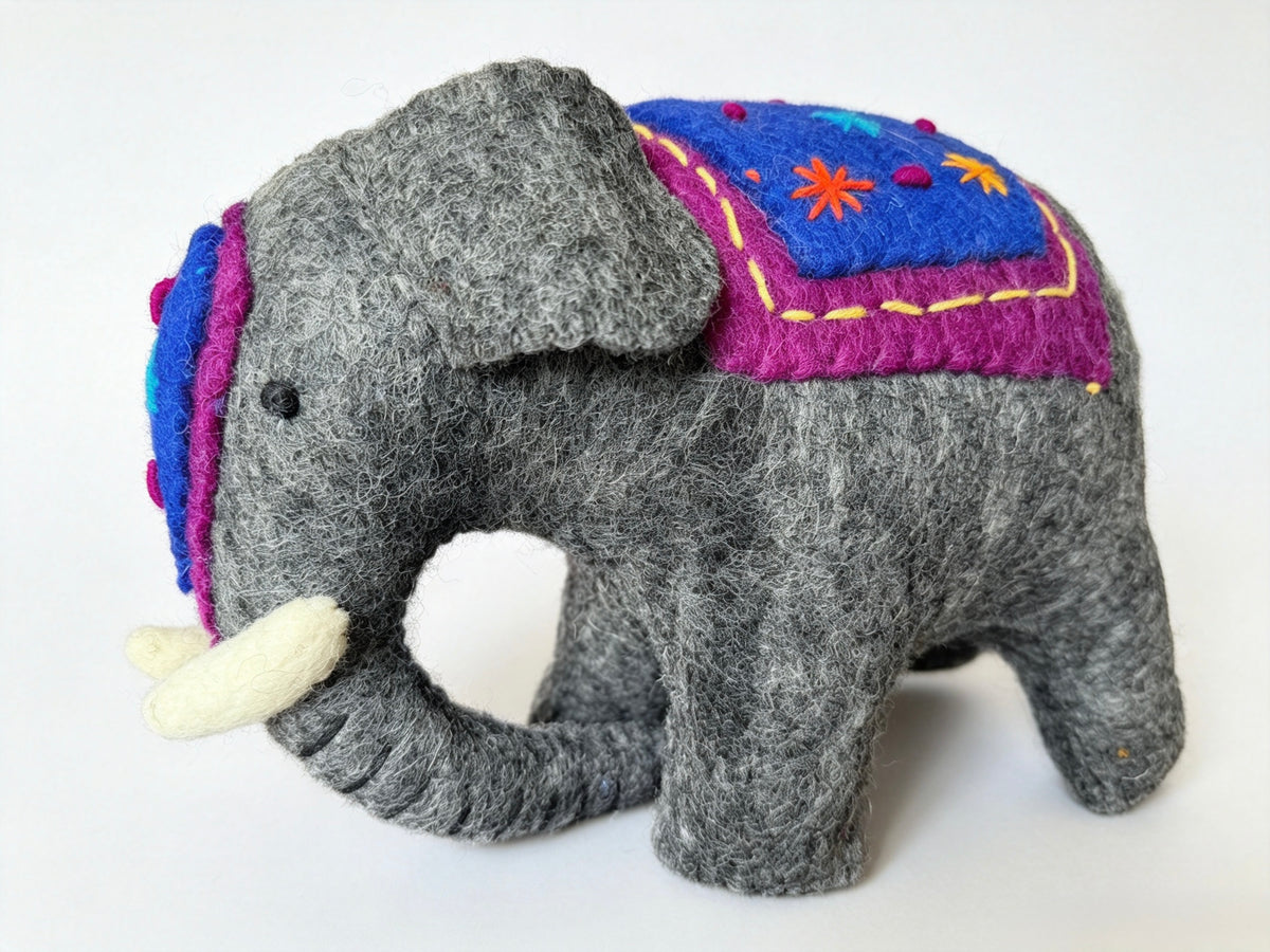 Handmade grey wool felt elephant decorative figurine on a white background