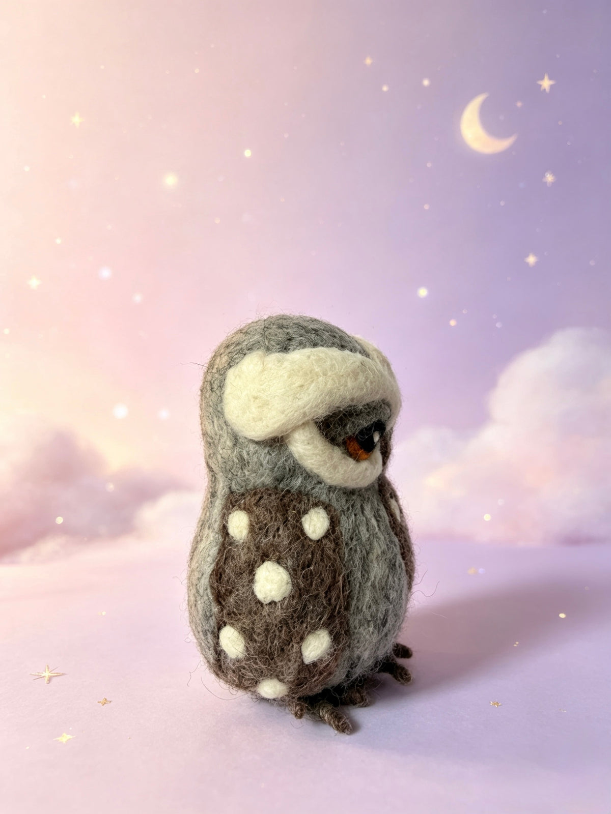 Side view of handmade wool felt owl ornament with spotted chest