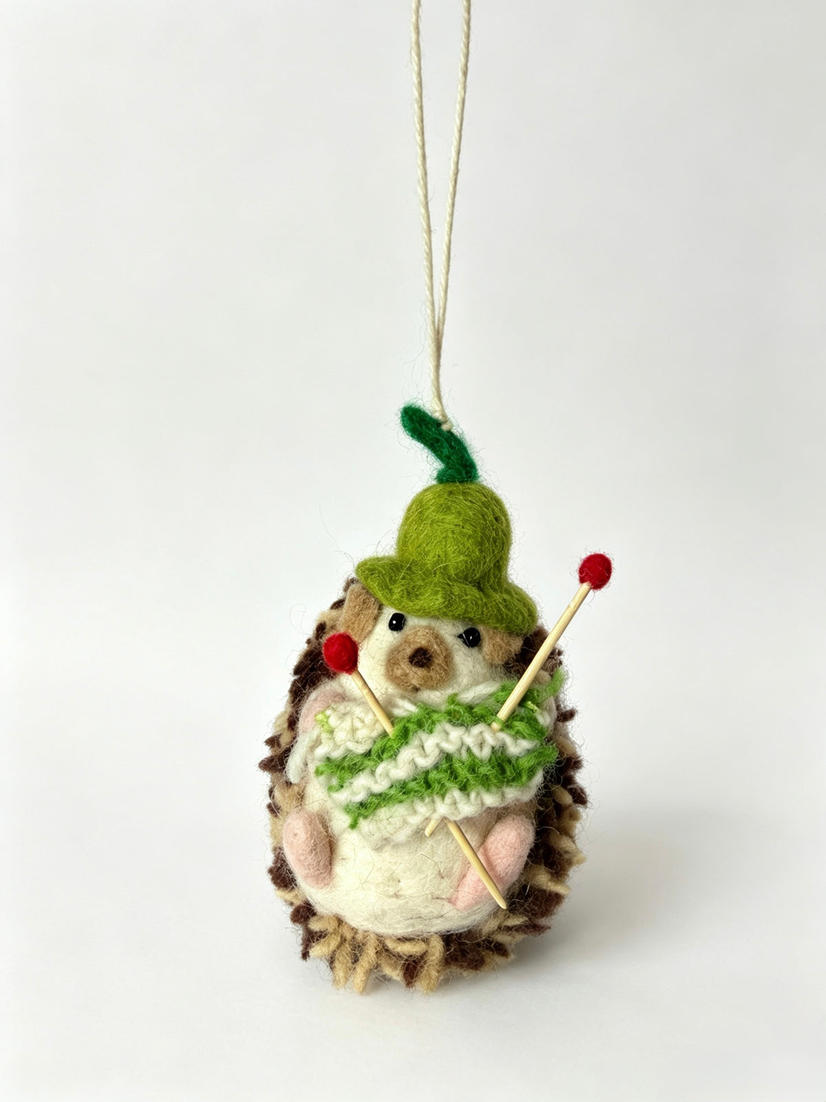 Handmade wool felt hedgehog Christmas ornament hanging by its string