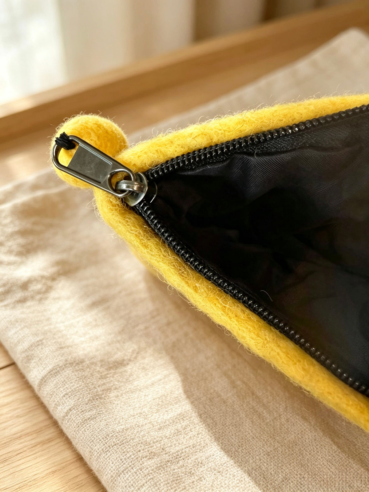 Back of handmade yellow wool felt hedgehog coin purse