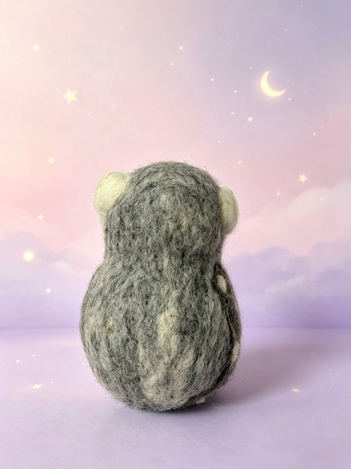 Profile view of handmade wool felt owl bird ornament with tiny felted feet