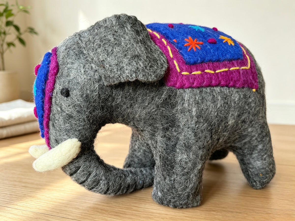 Side view of large handmade wool felt elephant display ornament