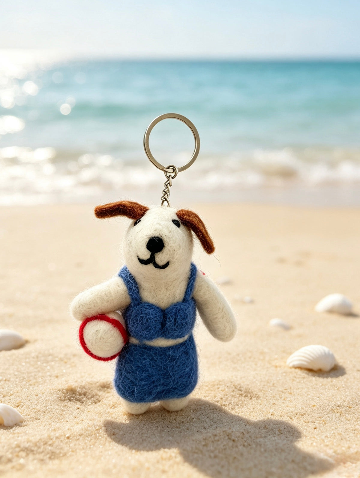 Front view of handmade felt beach volleyball dog bag charm with metal split ring