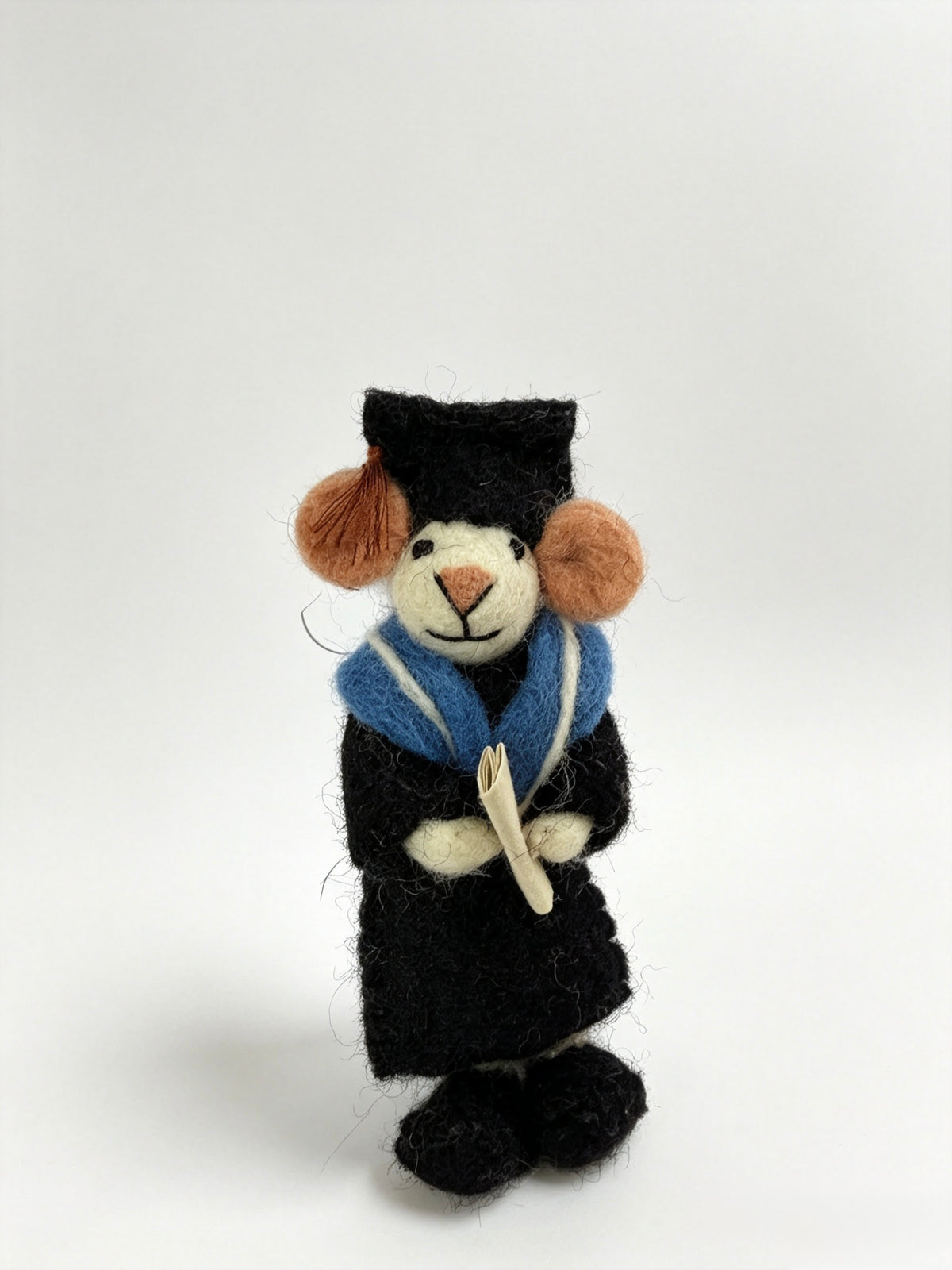 Handmade graduation mouse figurine standing with diploma in its hands