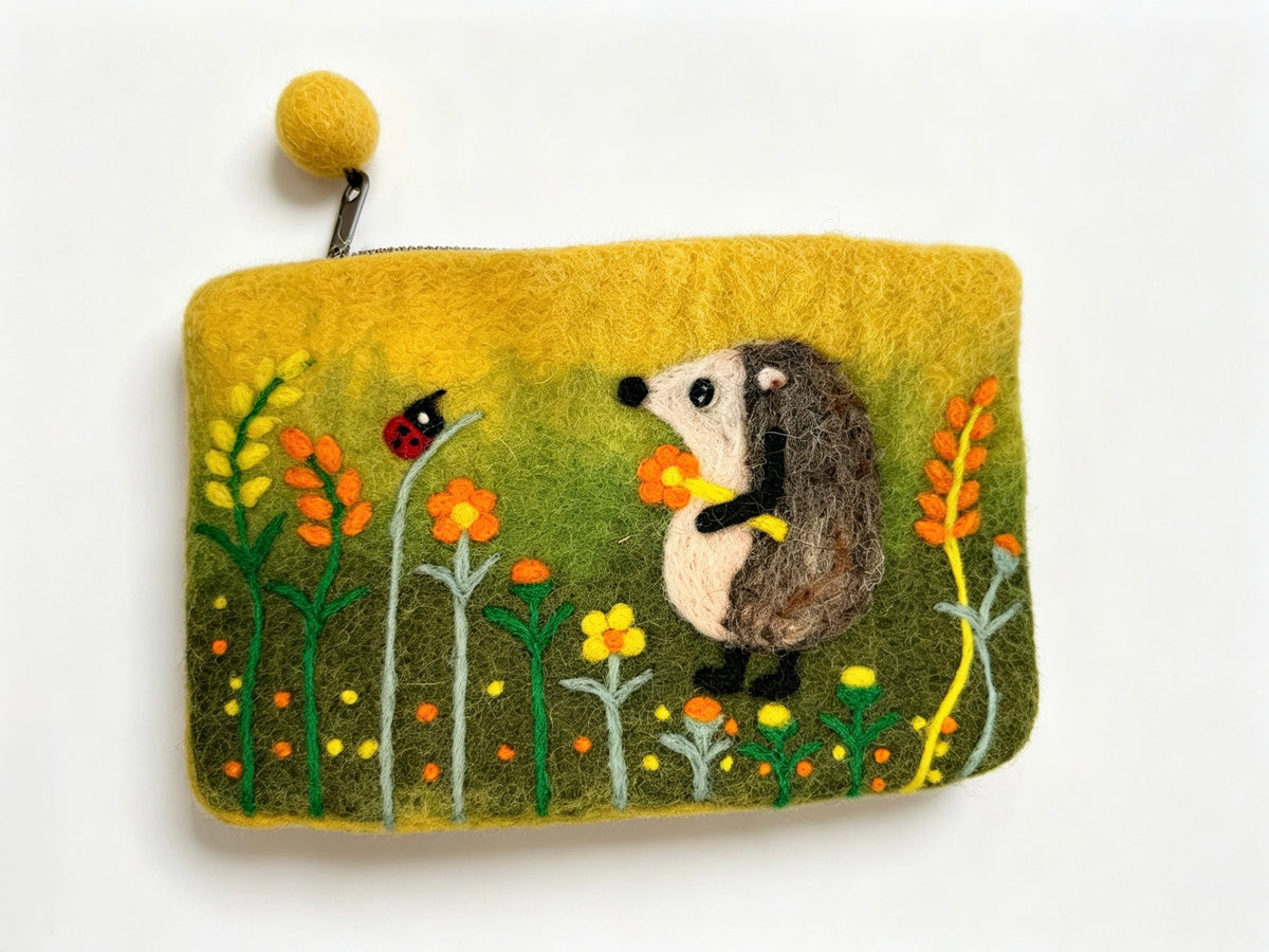 Front of handmade wool felt hedgehog coin purse with hedgehog and flowers