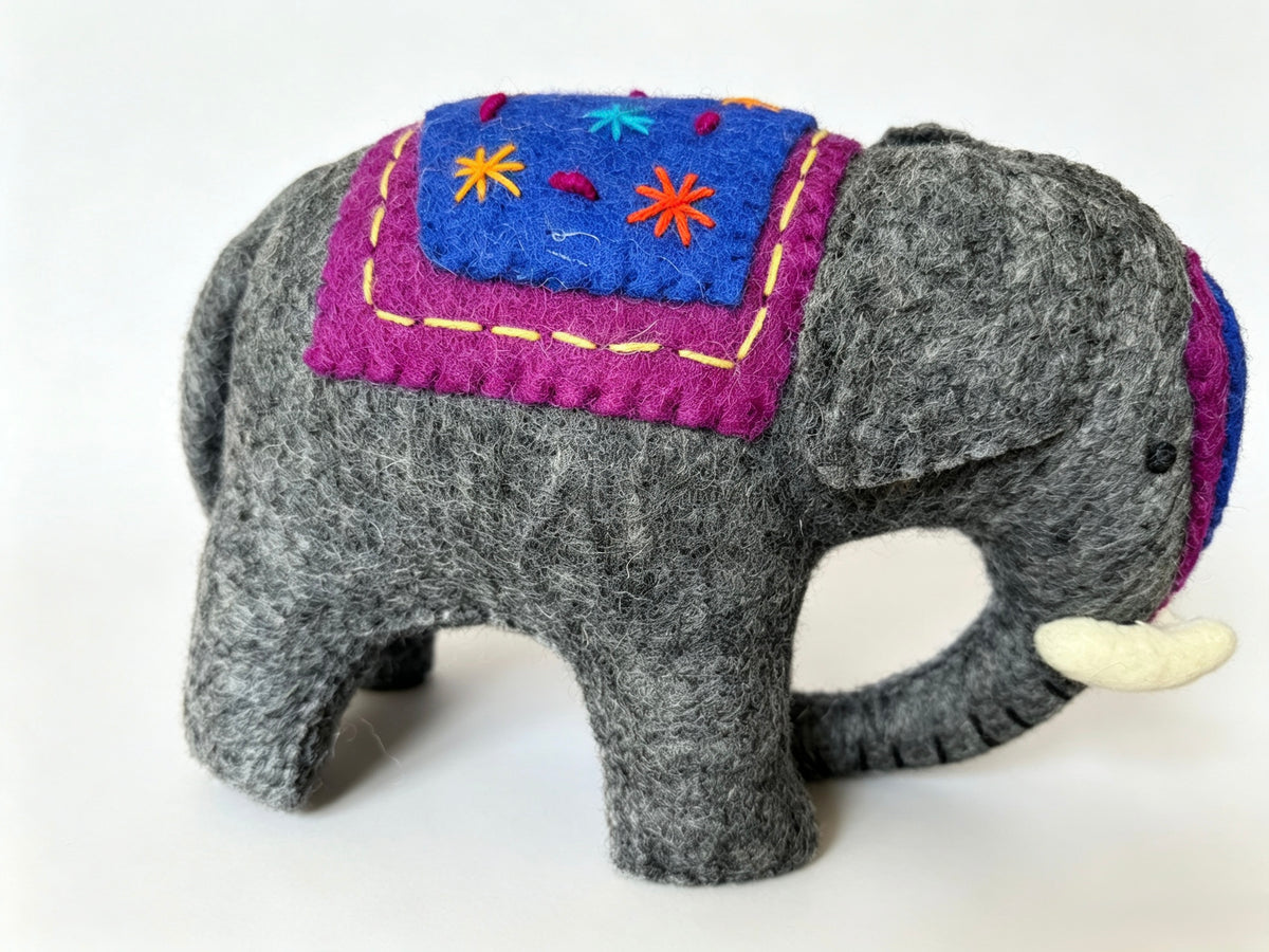 Handmade grey wool felt elephant figurine with embroidered blue and purple blankets