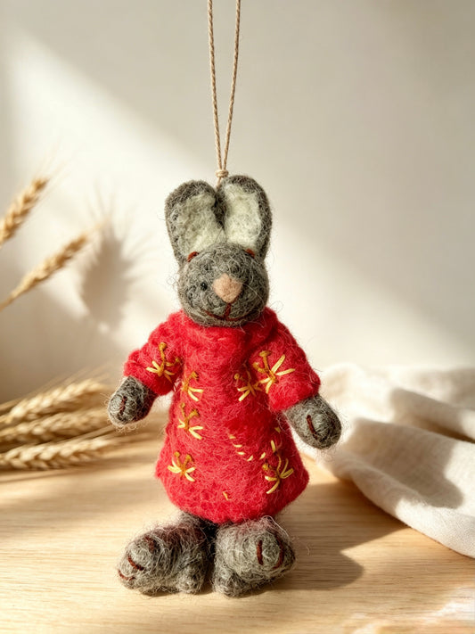 Handmade wool felt bunny rabbit ornament in a festive home setting