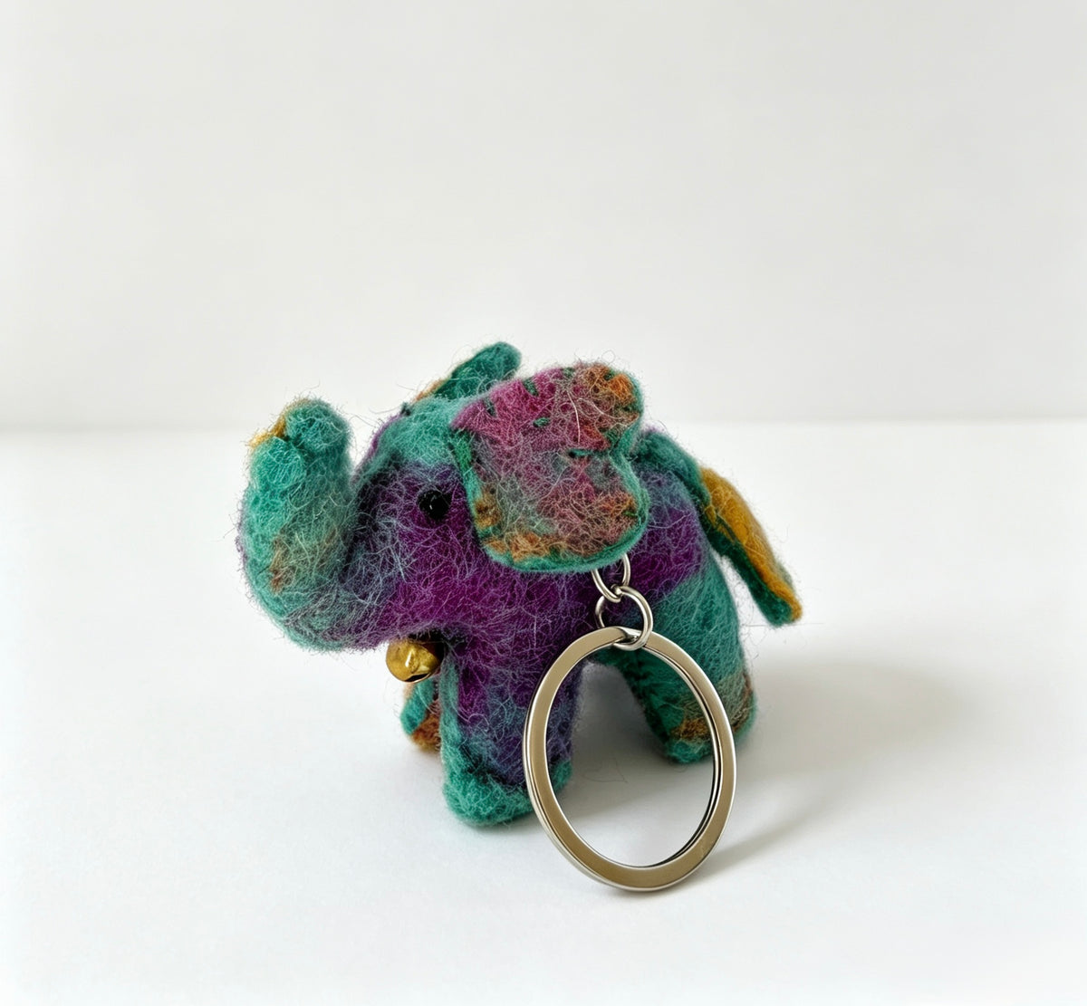 Handmade wool felt elephant bag charm held by its metal split ring