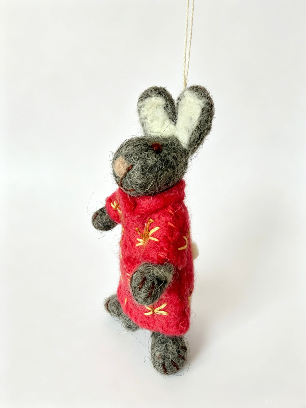 Front view of handmade wool felt bunny rabbit Christmas ornament in red outfit
